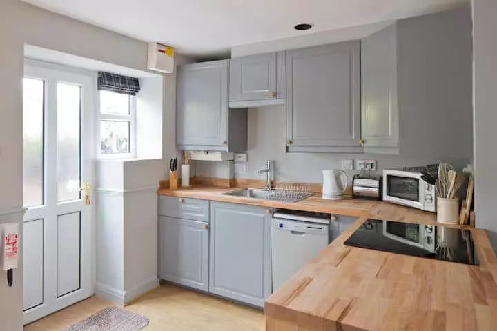 Open kitchen dining area with flower arrangement