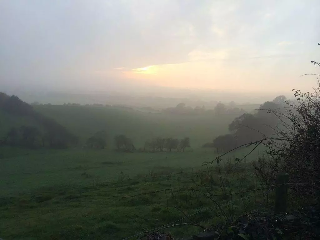 Misty dawn view across valley near the cottage