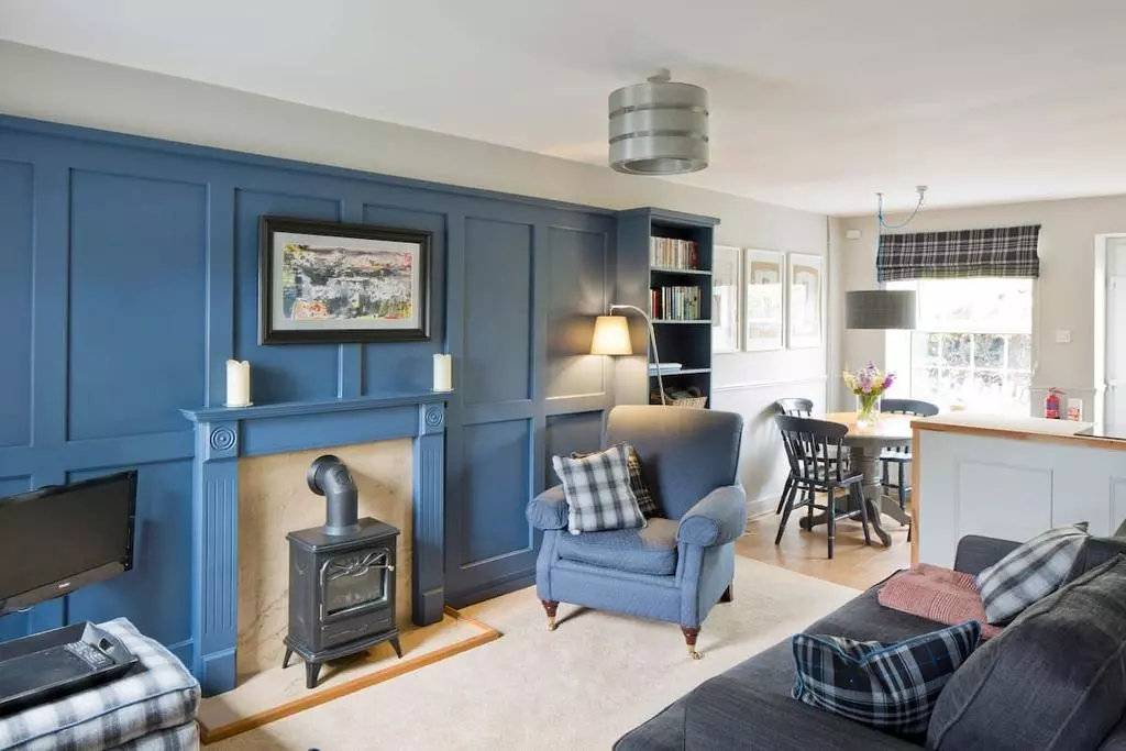 Blue armchair and tartan cushion in lounge