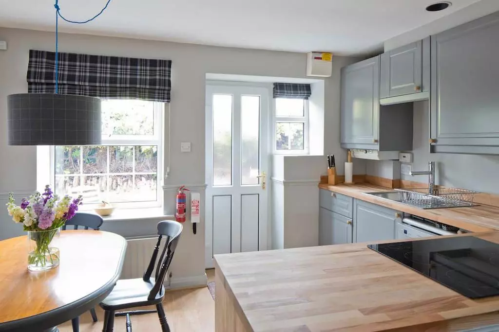 Stone exterior of Secret View Cottage under blue sky